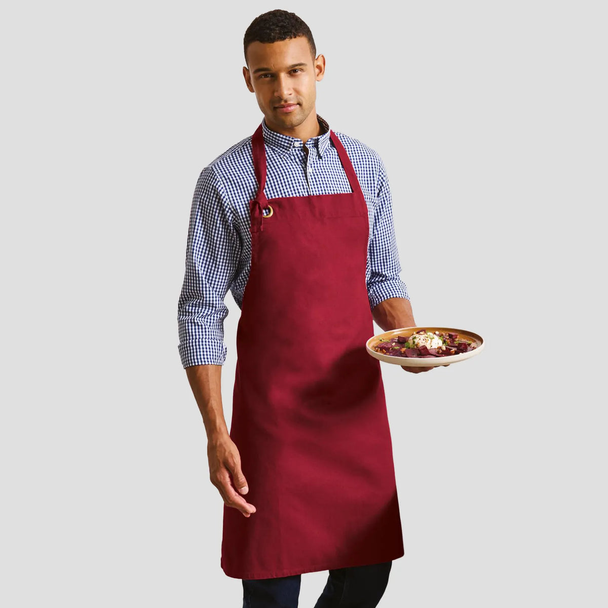 Model wearing the Premier Calibre Bib Apron PR130.
