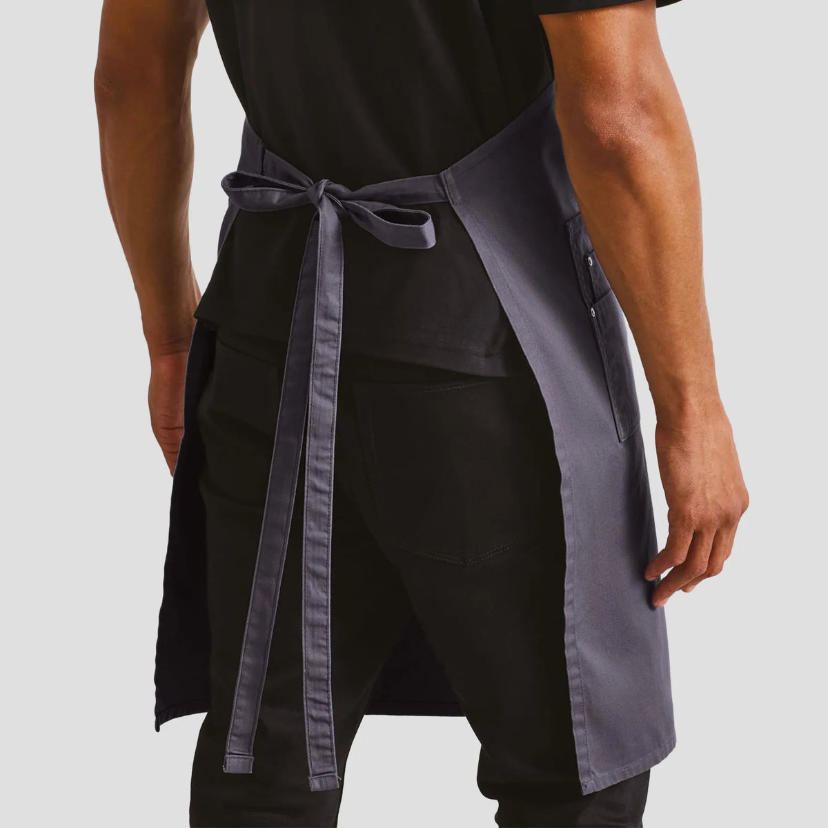 Back view of model wearing the Premier Cotton Chino Bib Apron PR132.