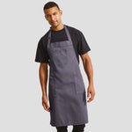 Model wearing the Premier Cotton Chino Bib Apron PR132.