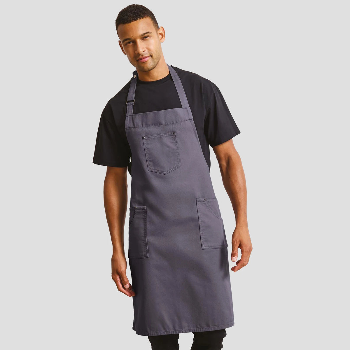 Model wearing the Premier Cotton Chino Bib Apron PR132.