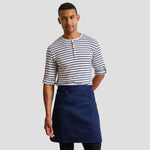 Model wearing the Premier 'Colours' Mid Length Apron with Pocket PR141.