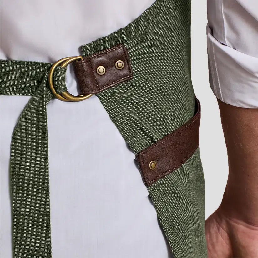 Close-up of model wearing the Premier Annex Oxford Bib Apron PR144.