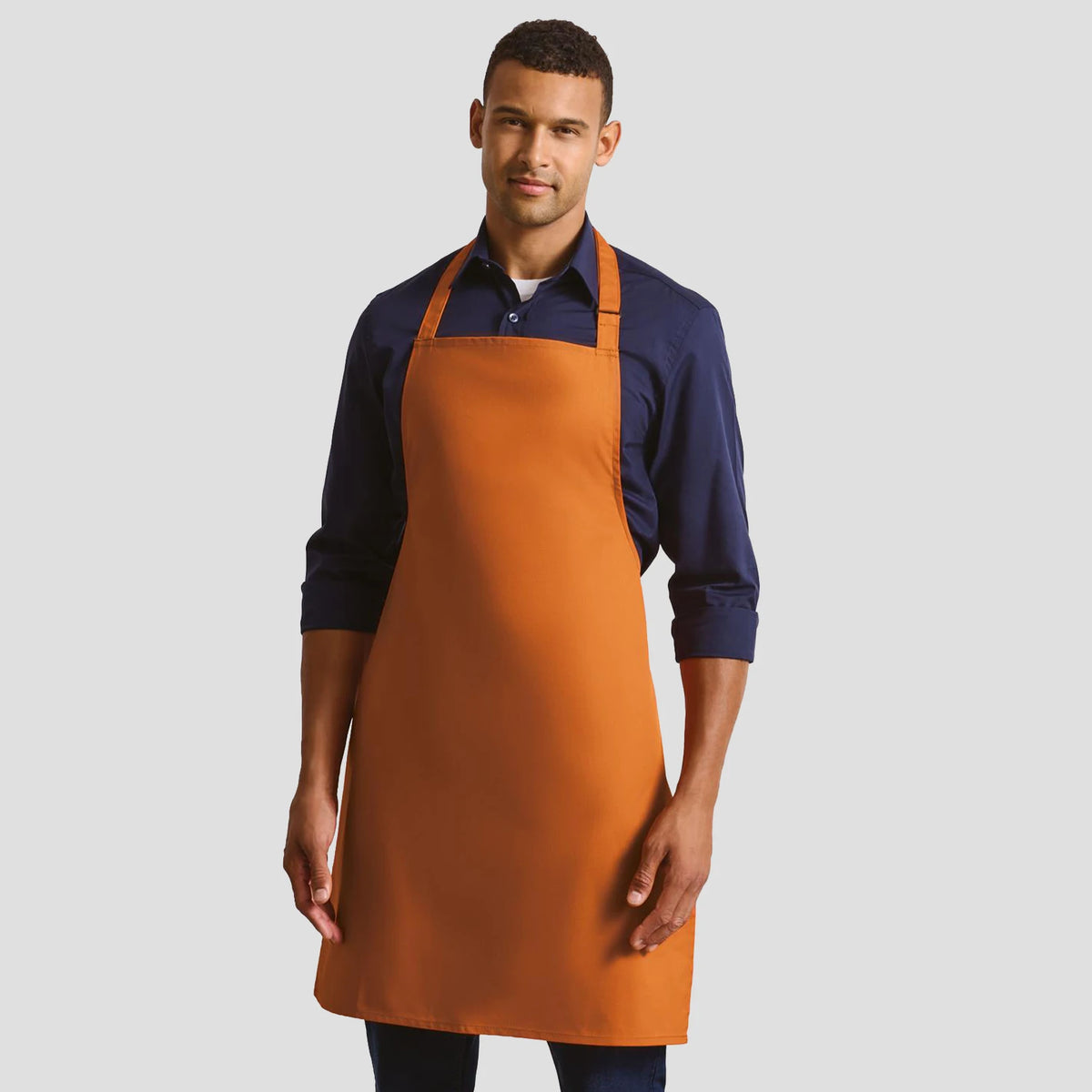 Model wearing the Premier 'Colours' Bib Apron PR150.