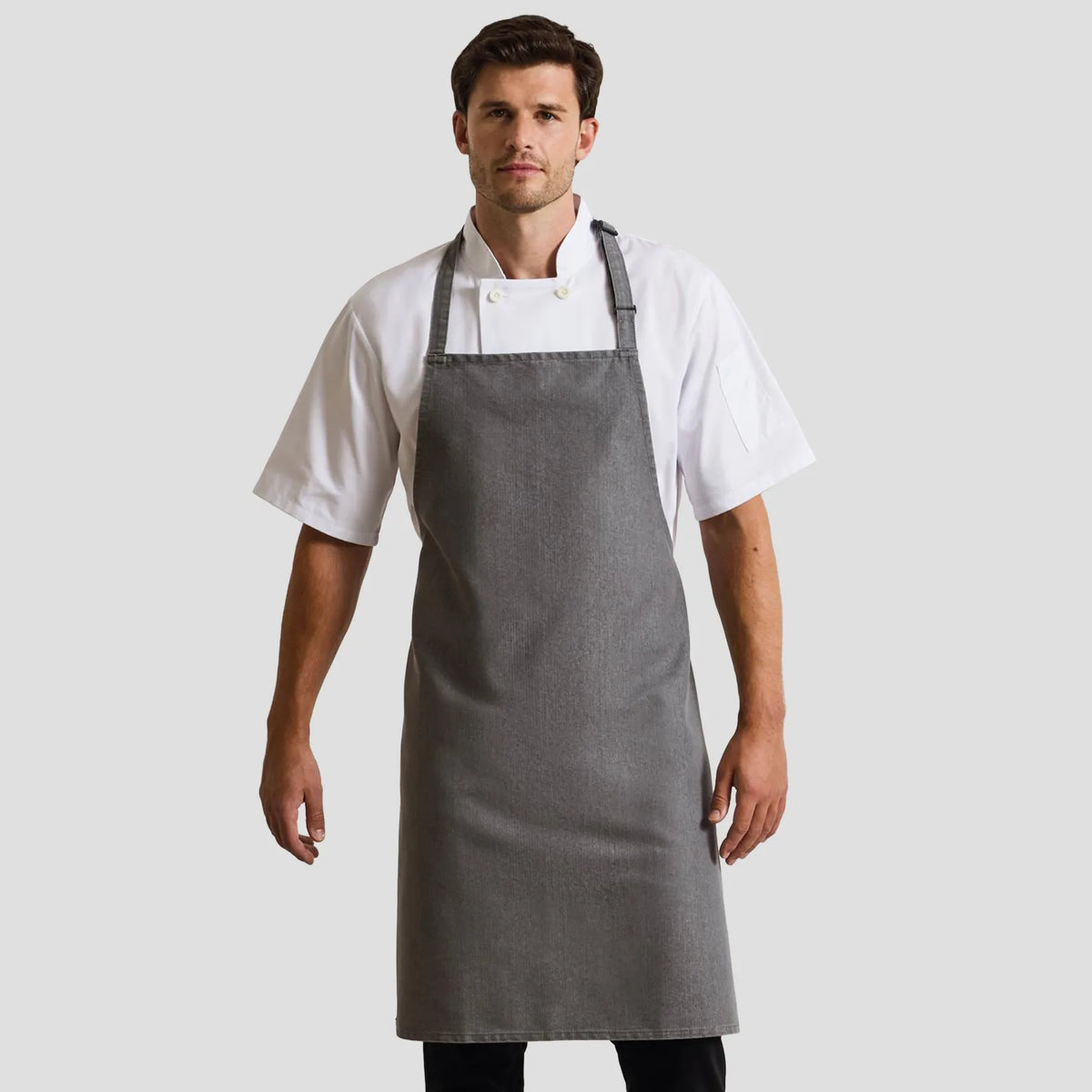 Model wearing the Premier 'Colours' Bib Apron PR150.