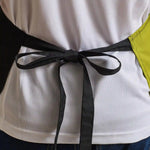 Close-up back view of model wearing the Premier Contrast Bib Apron PR162.