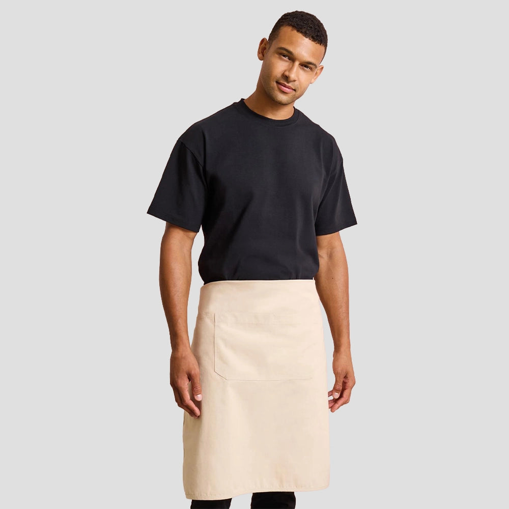 Model wearing the Premier 'Artisan's Choice' Double Pocket Canvas Apron PR181 in Natural - waist apron style.