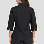 Back view of model wearing the Premier Ladies 3/4 Sleeve Poplin Blouse PR305 in Black.