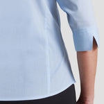 Sleeve closeup of model wearing the Premier Ladies 3/4 Sleeve Poplin Blouse in Light Blue.