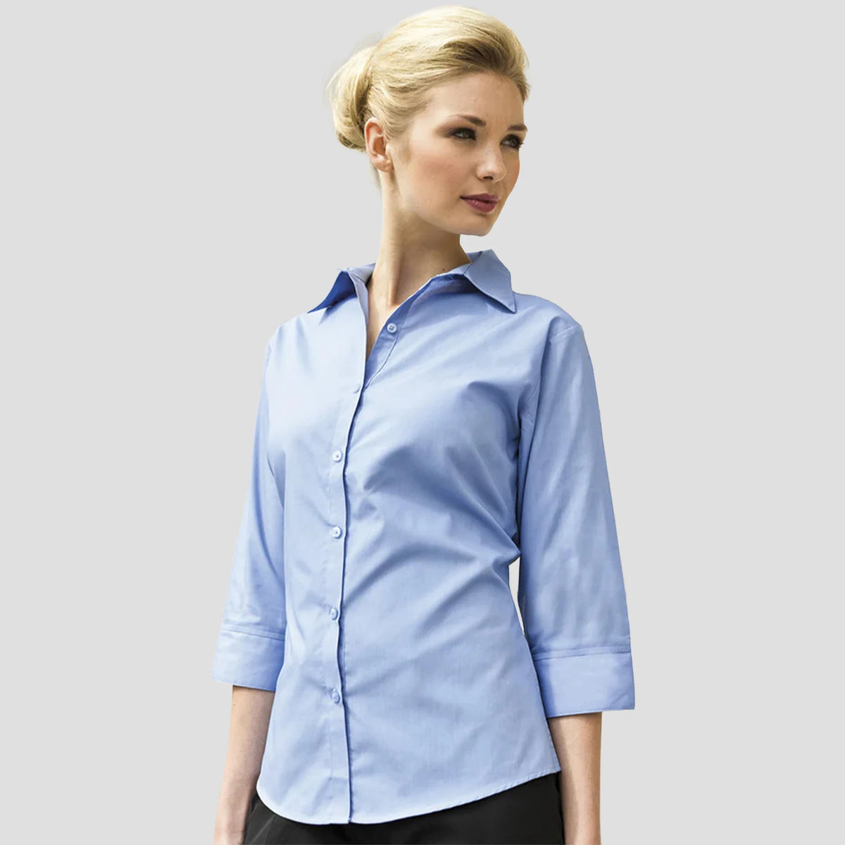 Model wearing the Premier Ladies 3/4 Sleeve Poplin Blouse in Mid Blue.