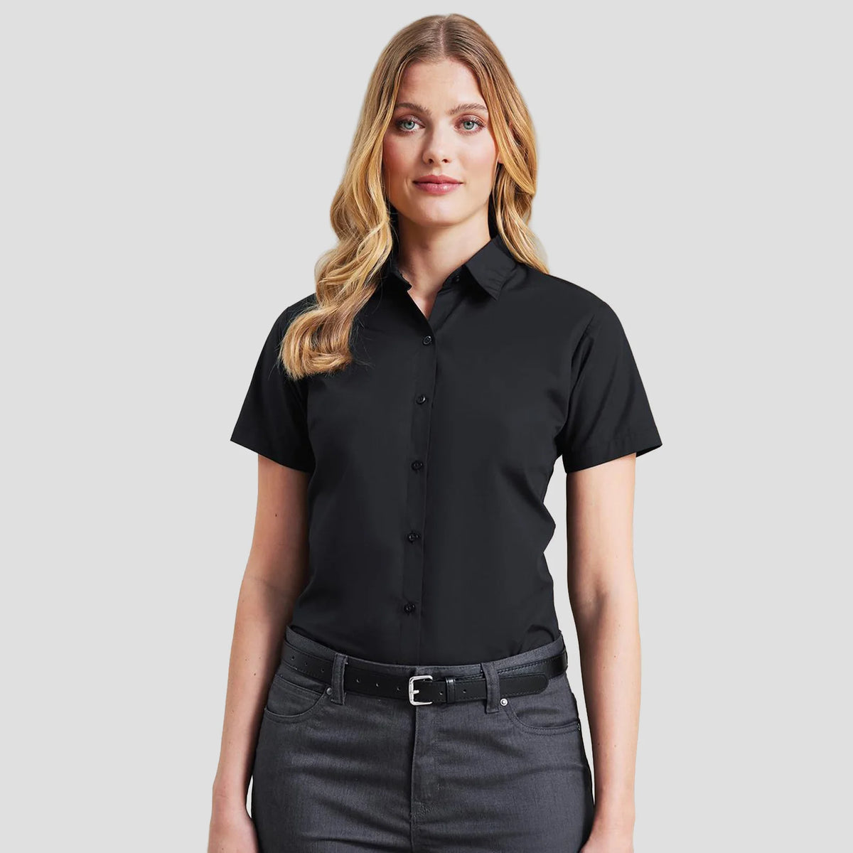 Model wearing the Premier Ladies Supreme Short Sleeve Poplin Shirt in Black.