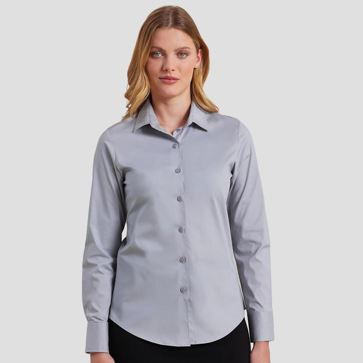 Model wearing the Premier Ladies Long Sleeve Stretch Fit Poplin Shirt PR344 (untucked).