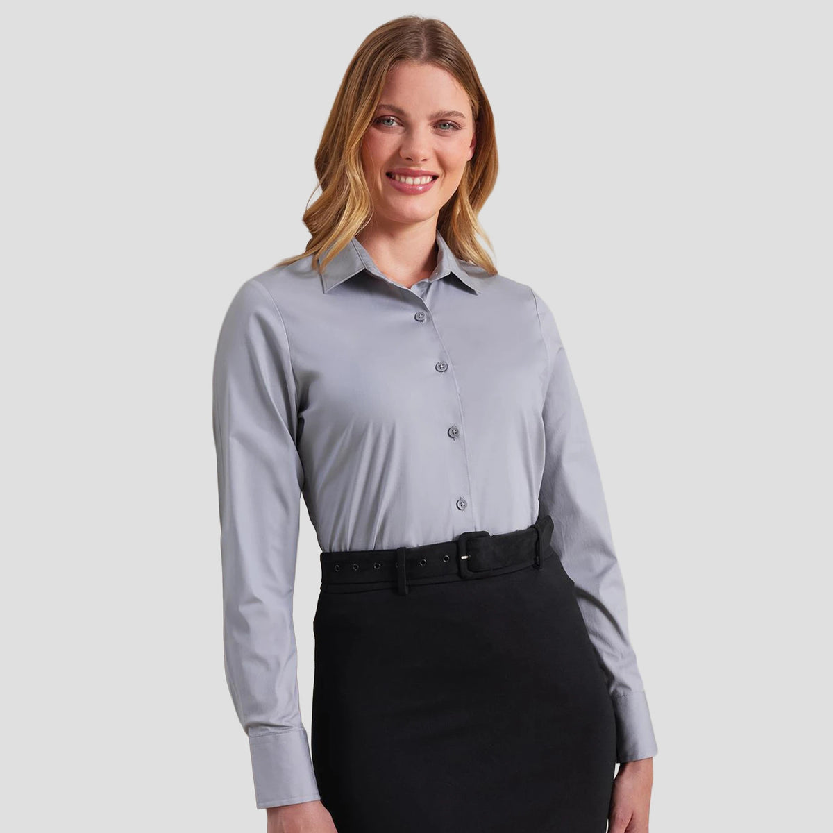 Model wearing the Premier Ladies Long Sleeve Stretch Fit Poplin Shirt PR344 (tucked in).