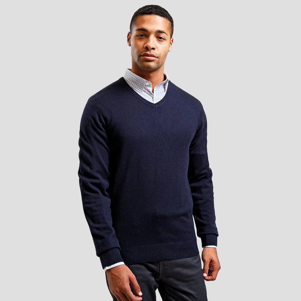 Model wearing the Premier Essential Acrylic V Neck Sweater PR400.