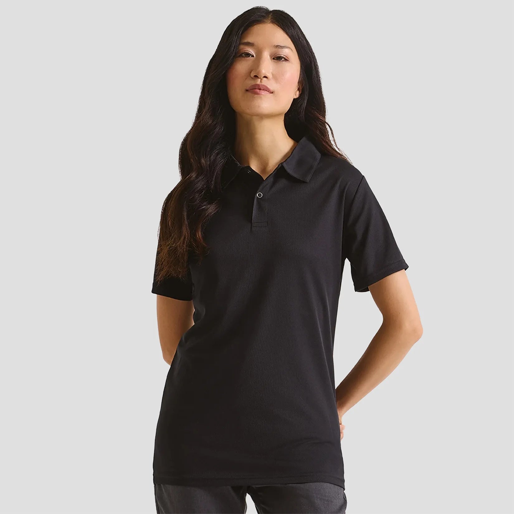 Female model wearing the Premier Coolchecker® Stud Piqué Polo Shirt PR612 in Black