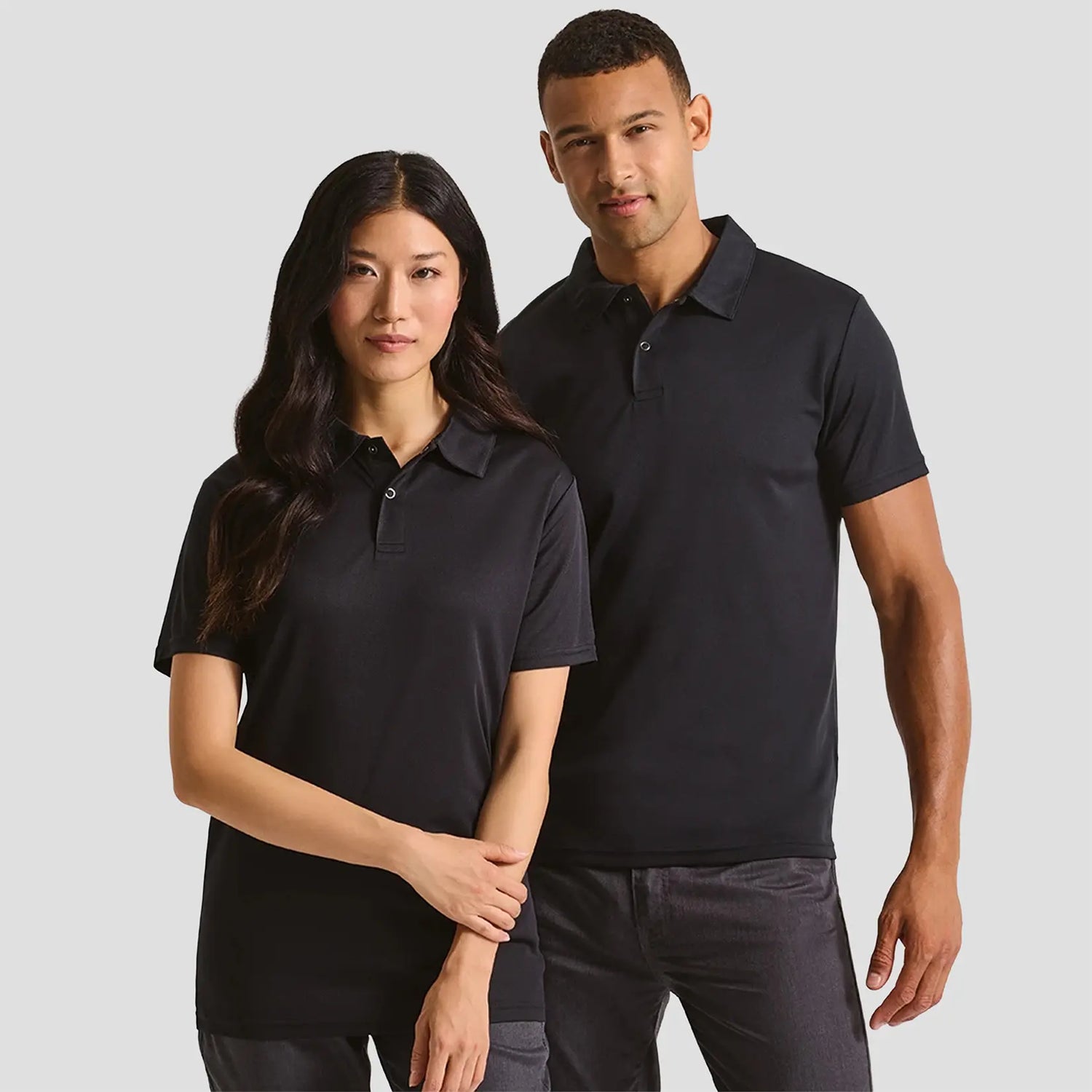 Models wearing the Premier Coolchecker® Stud Piqué Polo Shirt PR612 in Black