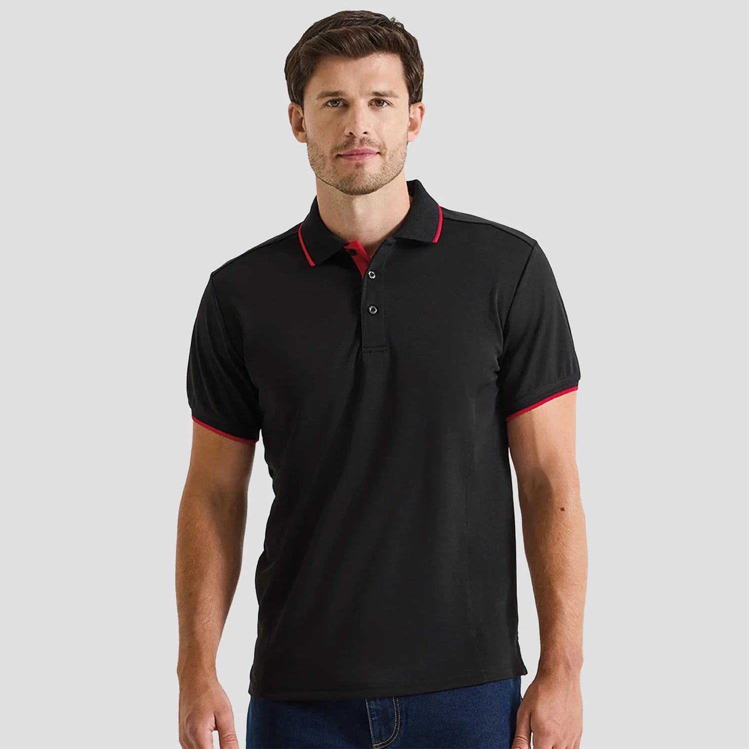 Model wearing the Premier Contrast Coolchecker® Piqué Polo Shirt PR618 in Black / Red