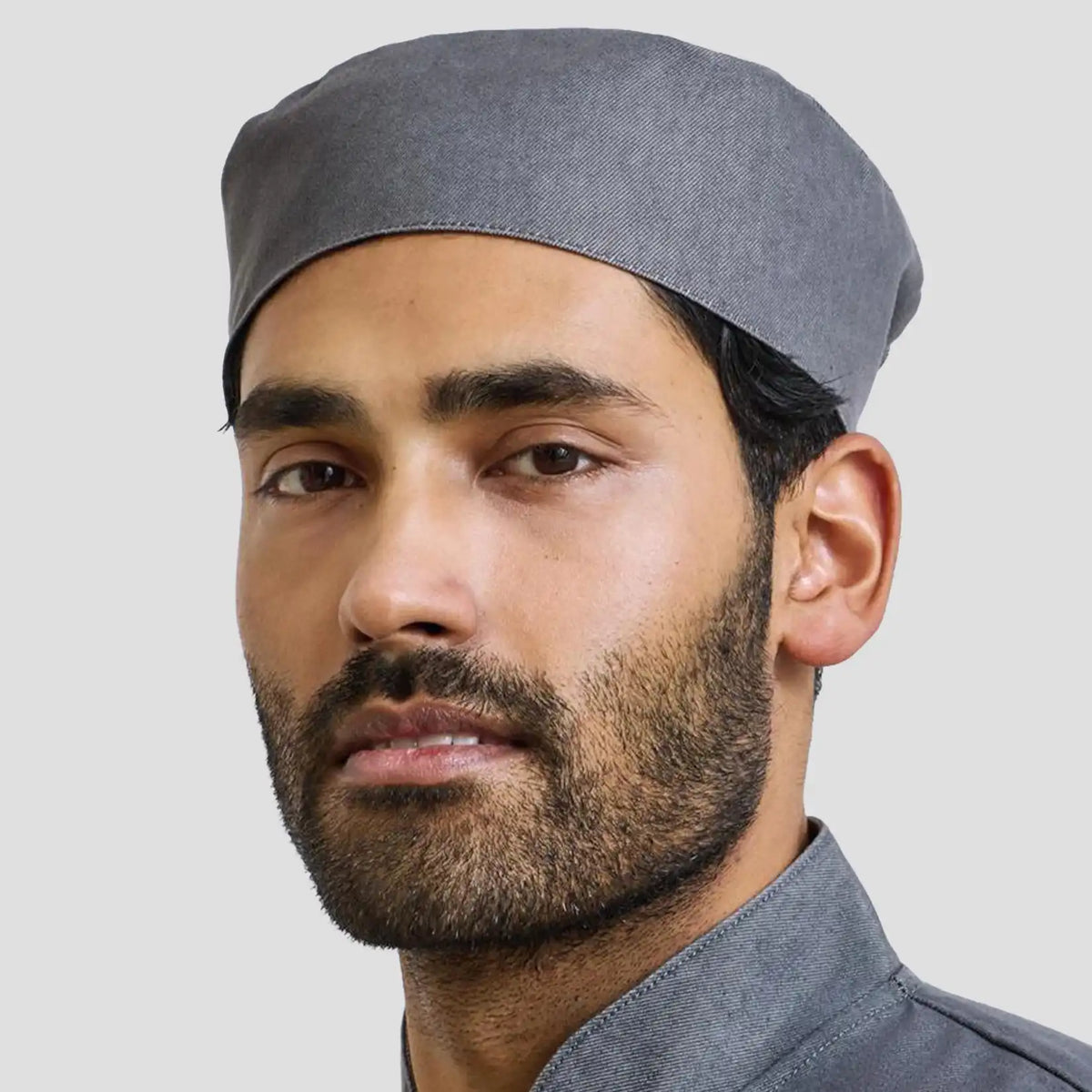 Model wearing the Premier Chef's Skull Cap PR653.
