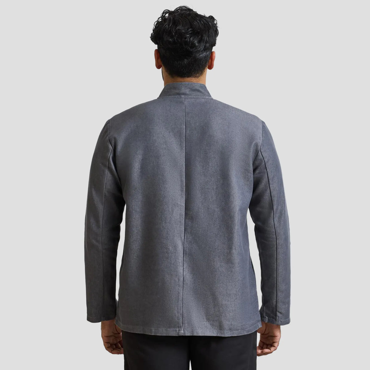 Rear view of model wearing the Premier Denim Chef's Jacket PR660.