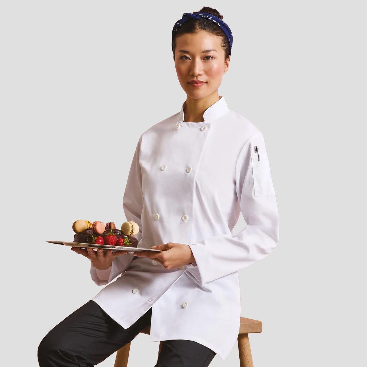 Model wearing the Premier Ladies Long Sleeve Chef's Jacket PR671.