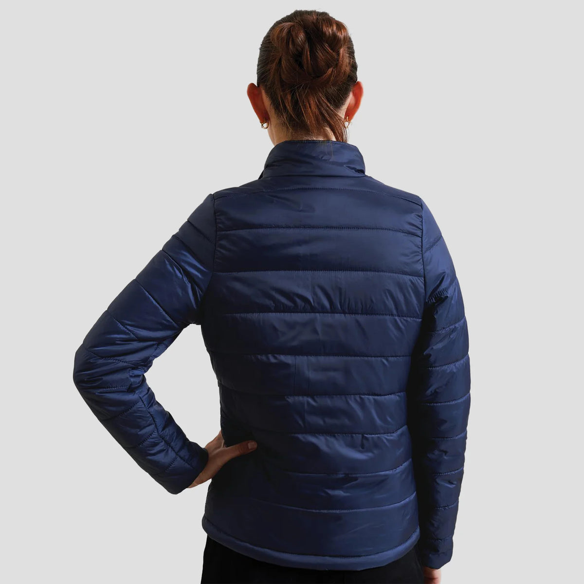 Back view of model wearing the Premier Ladies Recyclight® Padded Jacket.
