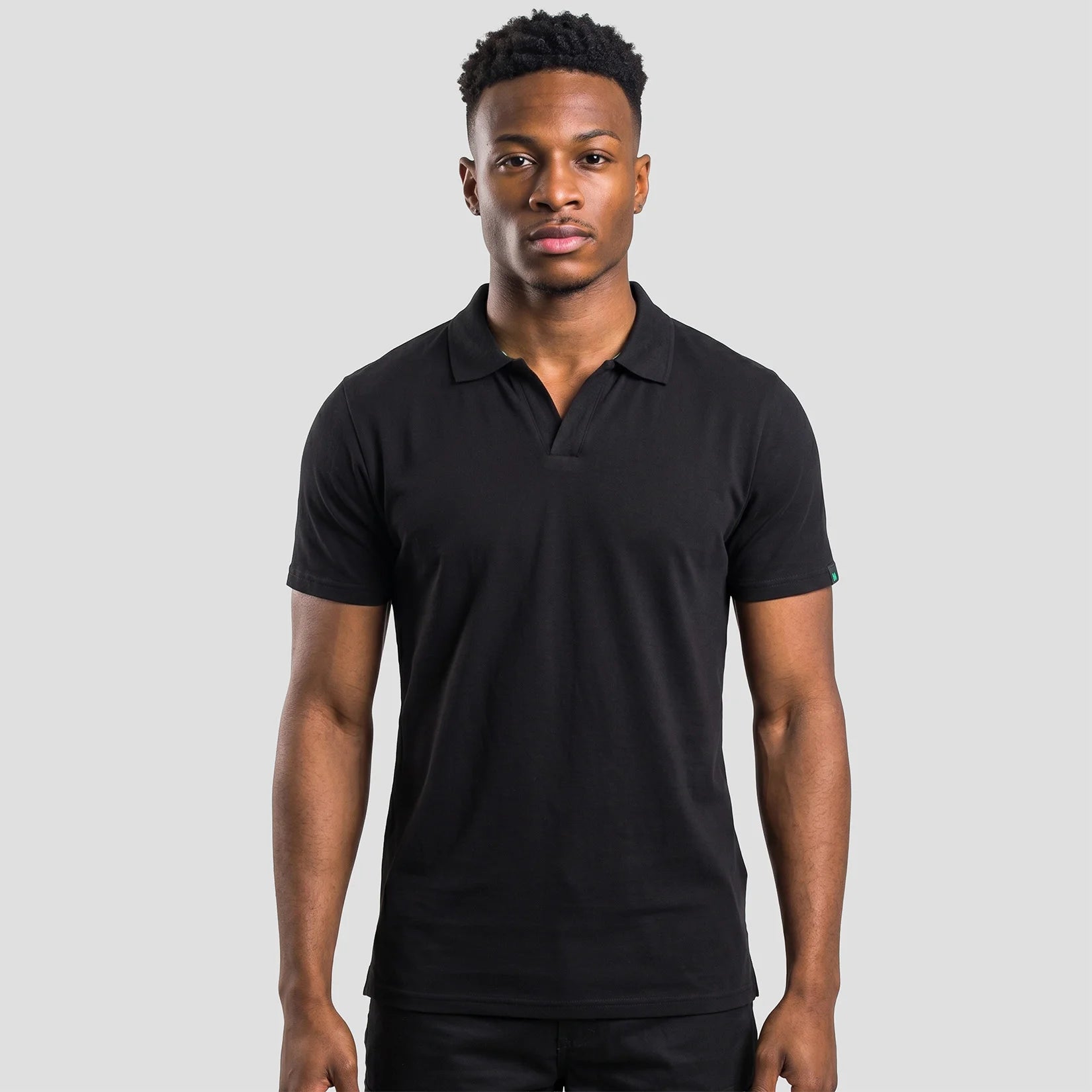 Model wearing the Portwest - Organic Cotton Recyclable Polo Shirt EC210 in Black