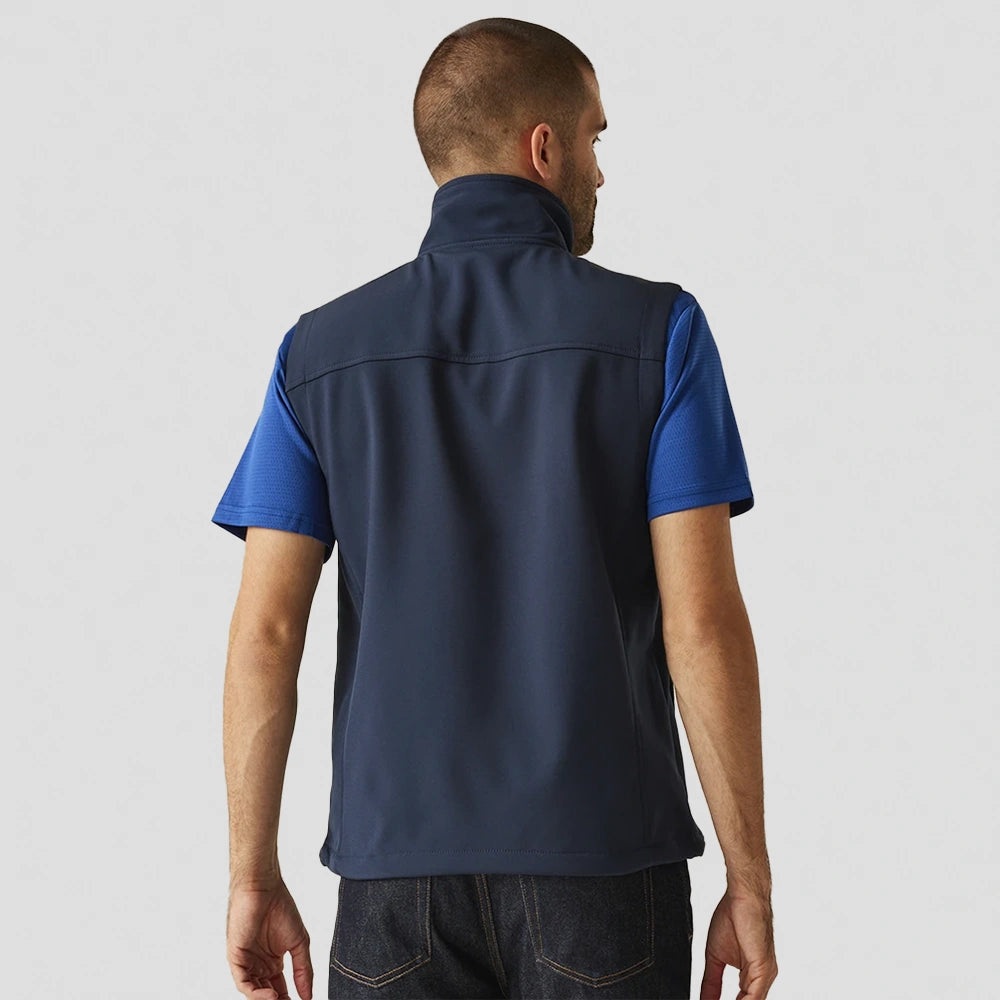 back view of model wearing navy Flux Soft Shell Bodywarmer