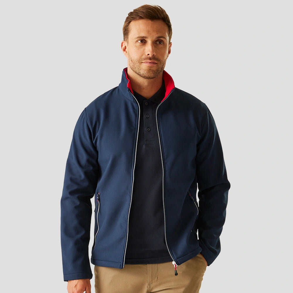 Model wearing the RG371 Regatta Ascender Two Layer Soft Shell Jacket in Navy/Red