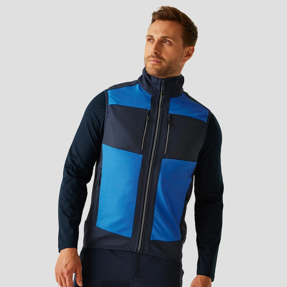 Male model wearing the Regatta E-Volve Unisex Two Layer Soft Shell Bodywarmer in Strong Blue / Navy