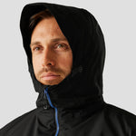 Close-up of model, with hood up, wearing the Regatta Navigate Waterproof Insulated Jacket in Black / New Royal Blue