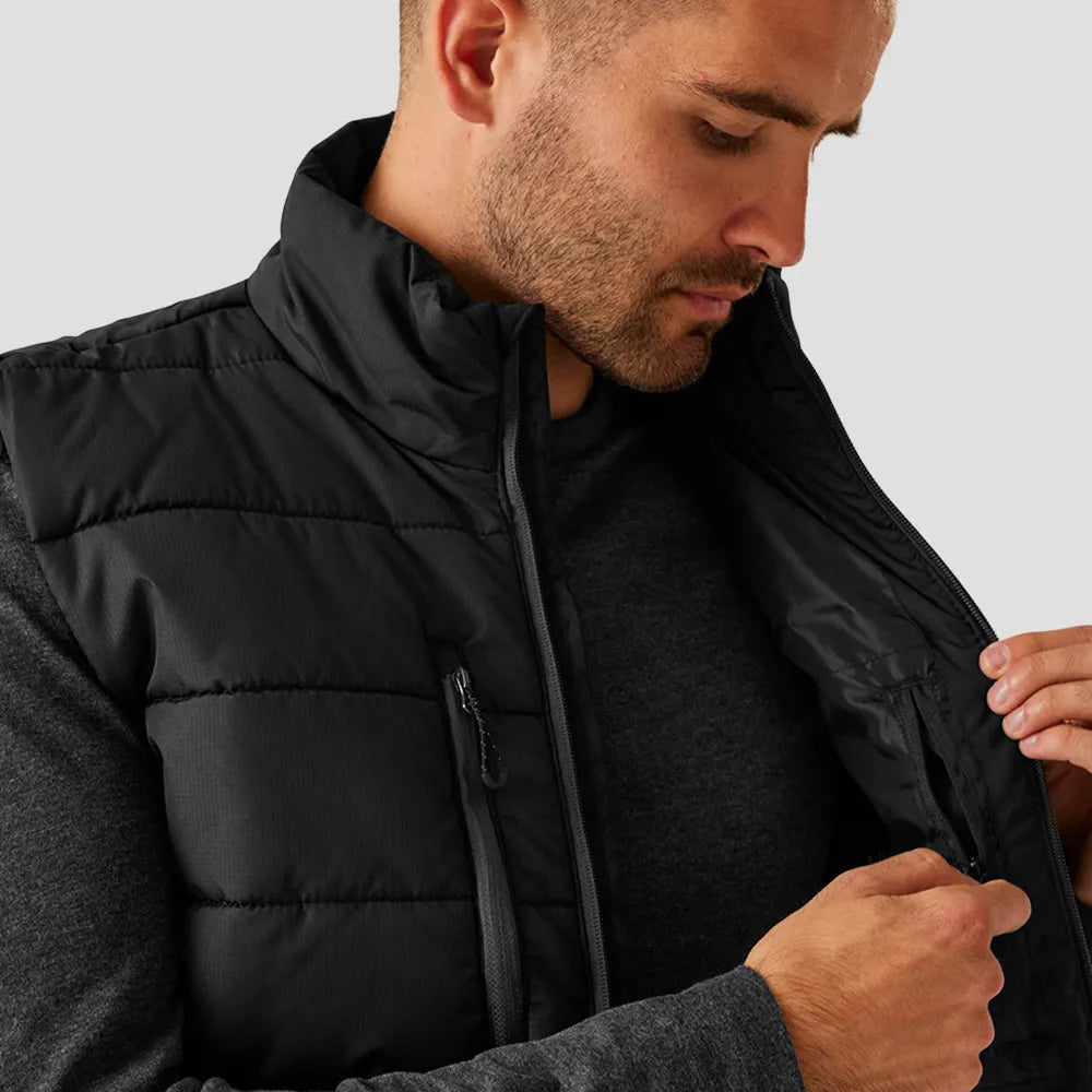 Model opening the inside pocket of the Regatta Navigate Thermal Bodywarmer in Black / Seal Grey