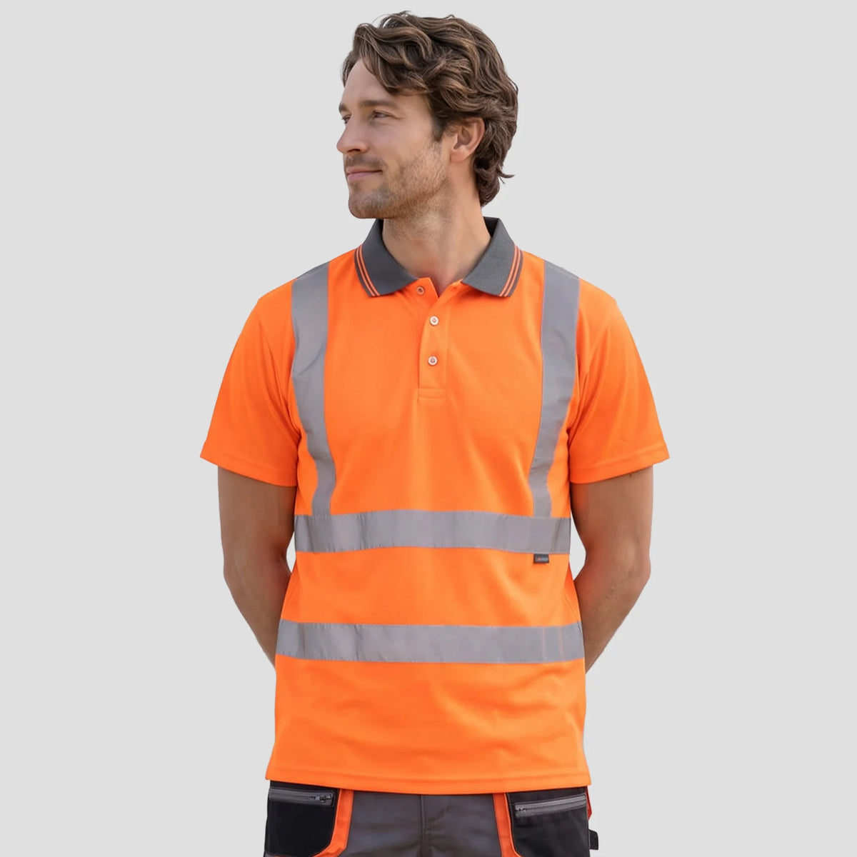 Model wearing the Hi-Vis Polo Shirt S/S in Orange.