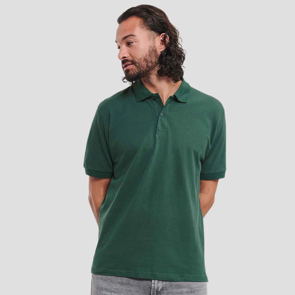 Model wearing the Russell Classic Cotton Piqué Polo Shirt 569M in Bottle Green