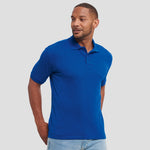 Model wearing the Russell Hardwearing Poly/Cotton Piqué Polo Shirt 599M in Royal Blue
