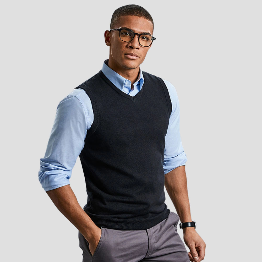 Model wearing the Russell Collection Sleeveless Cotton Acrylic V Neck Sweater 716M in Black