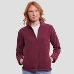 Model wearing the Russell Ladies Outdoor Fleece 870F in burgundy