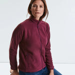 Model wearing the Russell Ladies Outdoor Fleece 870F in Burgundy