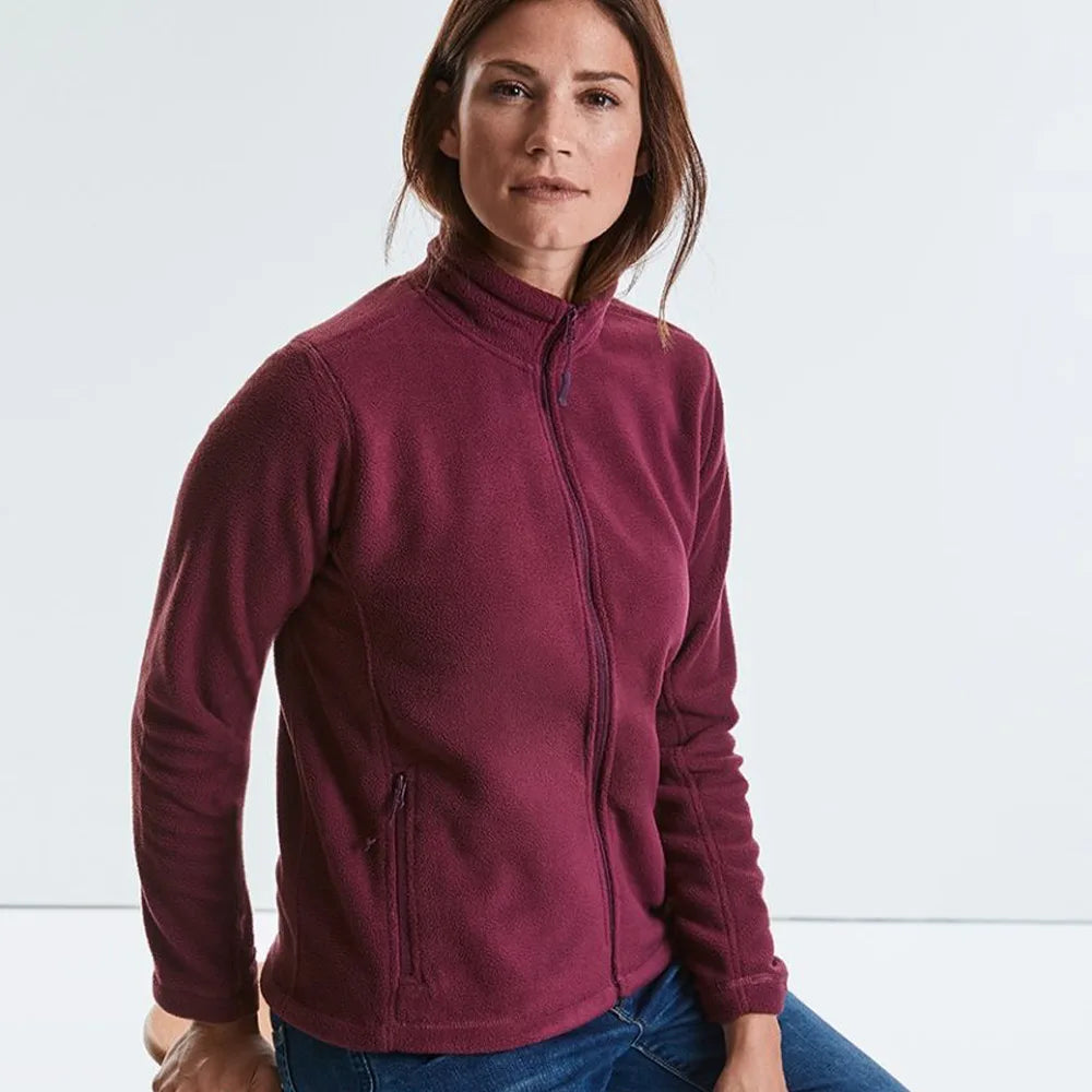 Model wearing the Russell Ladies Outdoor Fleece 870F in Burgundy