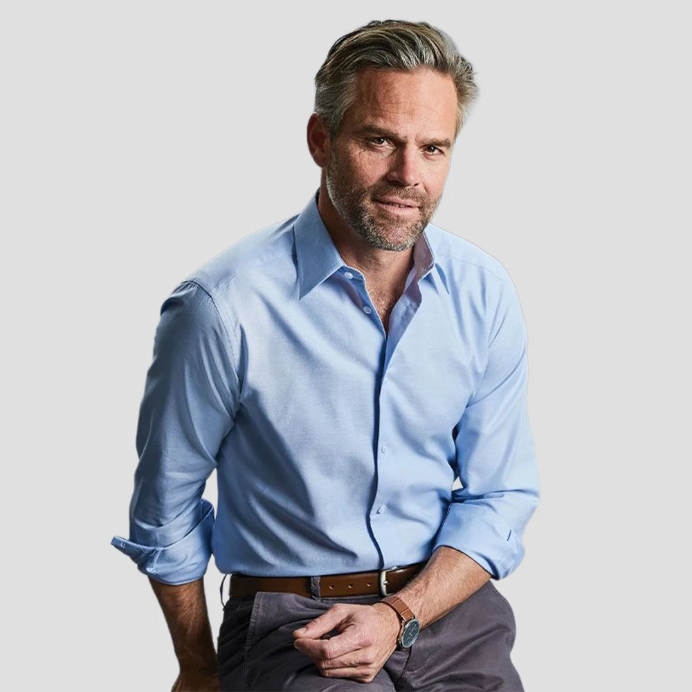 Model wearing the Russell Collection Long Sleeve Tailored Oxford Shirt 922M in Oxford Blue