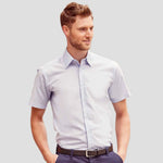 Model wearing the Russell Collection Short Sleeve Tailored Oxford Shirt in white