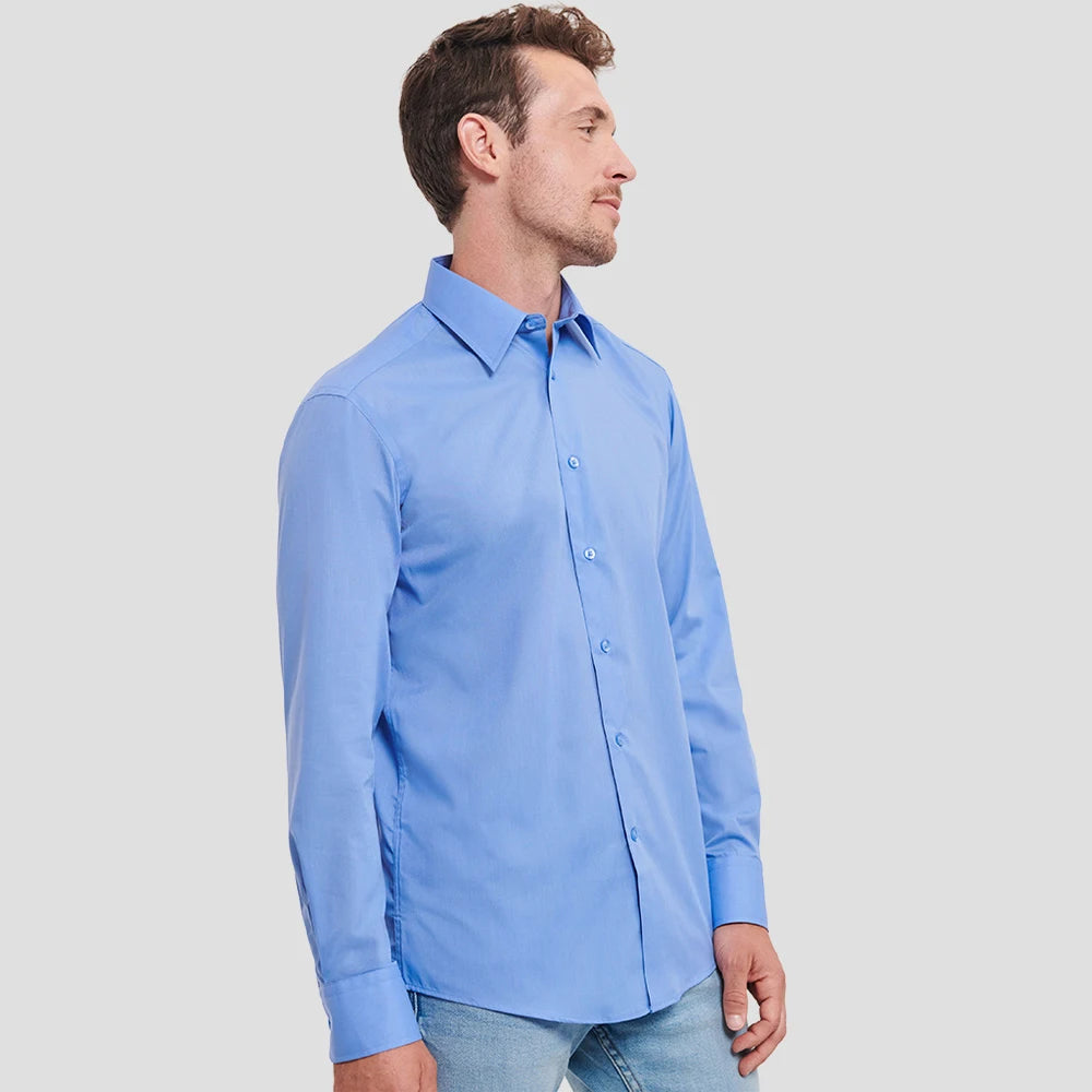 Side view of Model wearing the Russell Collection Long Sleeve Tailored Poplin Shirt 924M in Corporate Blue