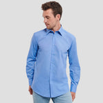 Model wearing the Russell Collection Long Sleeve Tailored Poplin Shirt 924M in Corporate Blue
