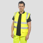 Model wearing the Portwest - Hi-Vis 4-in-1 Traffic Jacket (Inner bodywarmer) in Yellow.