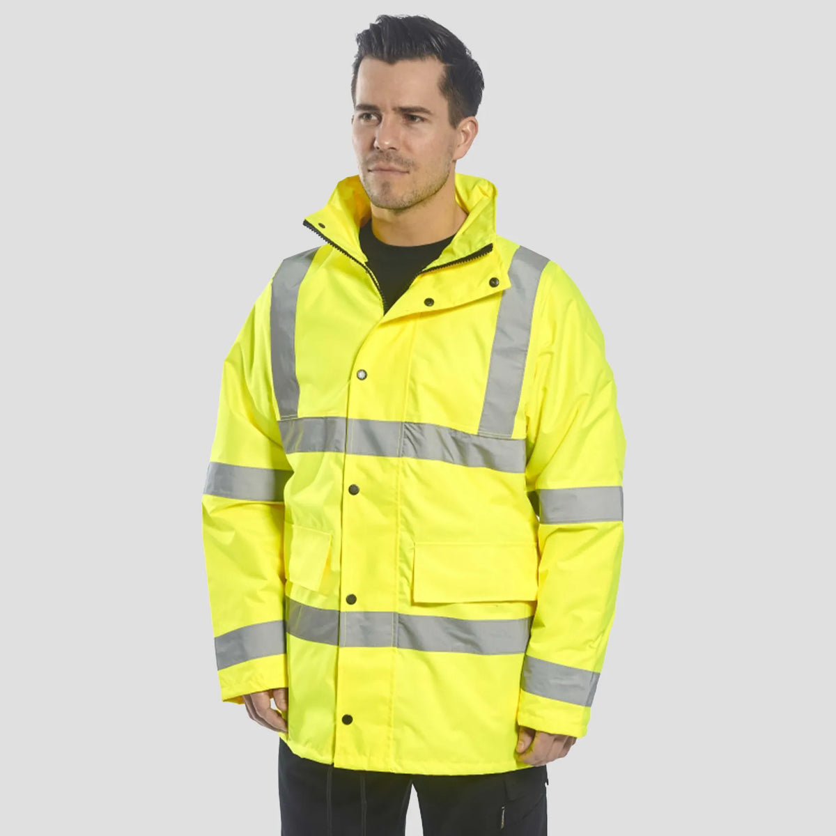 Model wearing the Portwest - Hi-Vis 4-in-1 Traffic Jacket in Yellow.