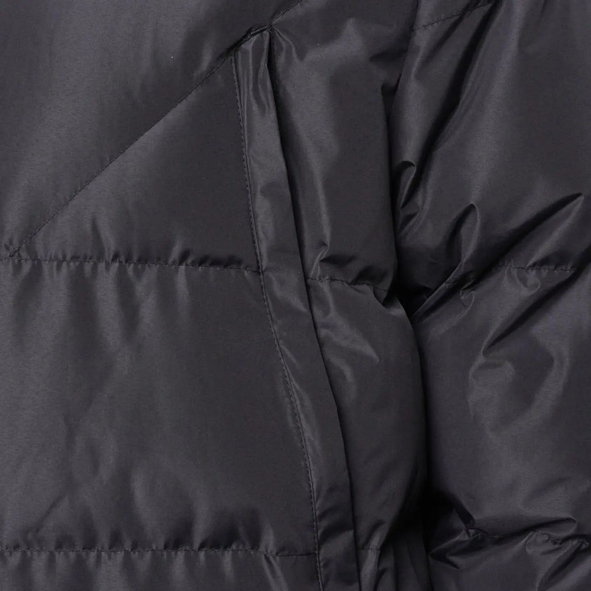 Close-up fabric view of the Surridge Sport Long Padded Bench Coat in Black.