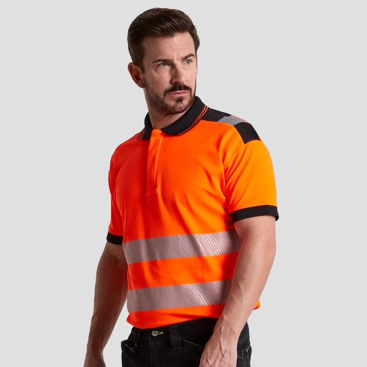 Model wearing orange and black Portwest - PW3 Hi-Vis Cotton Comfort Polo Shirt S/S