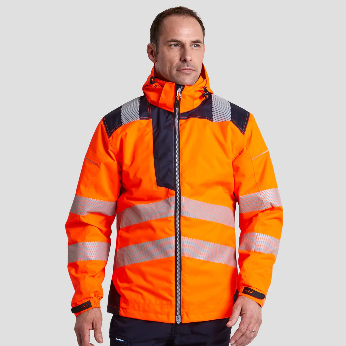 Model wearing the PW3 Hi-Vis Winter Jacket T400 in Orange.