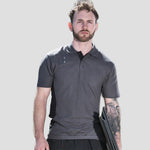 Model wearing the TuffStuff Pro Work Polo Shirt in Charcoal / Black