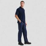 full side view of model wearing navy Classic Polo Shirt - Corporate Colours UC101