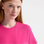 close up of woman wearing hot pink tee