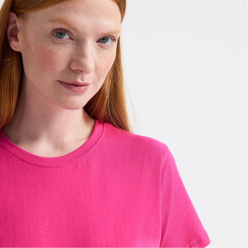 close up of woman wearing hot pink tee